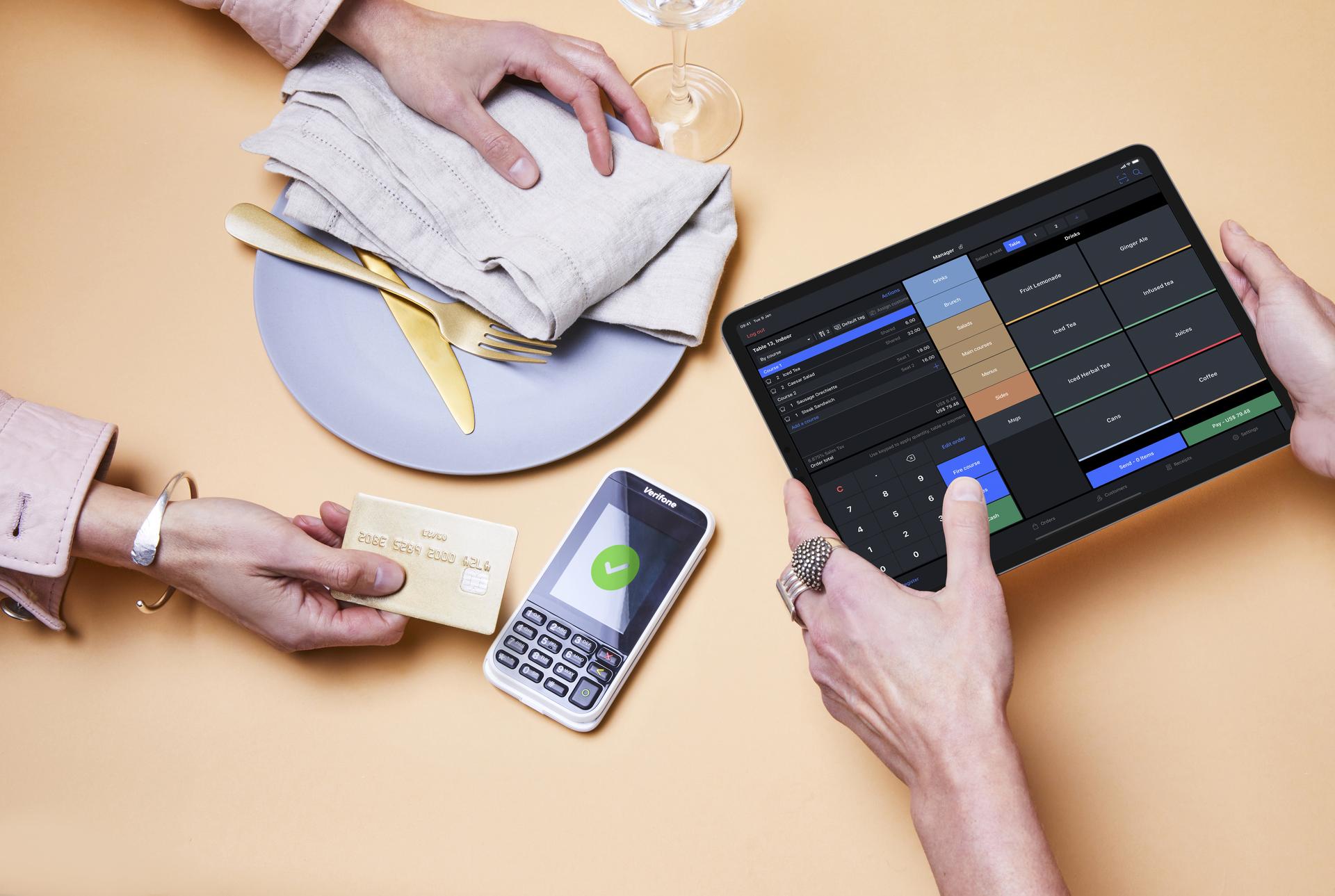 Person paying with credit card at terminal with Lightspeed interface