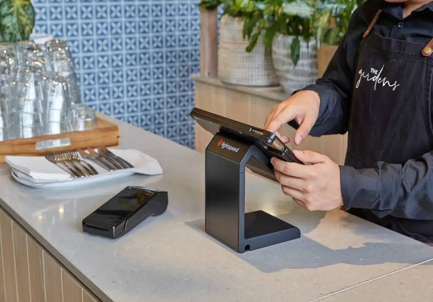 Medewerker rekent af via LightSpeed kassasoftware op een moderne POS-terminal in een horecaomgeving.